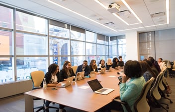 Board of directors meet in a conference room. 
