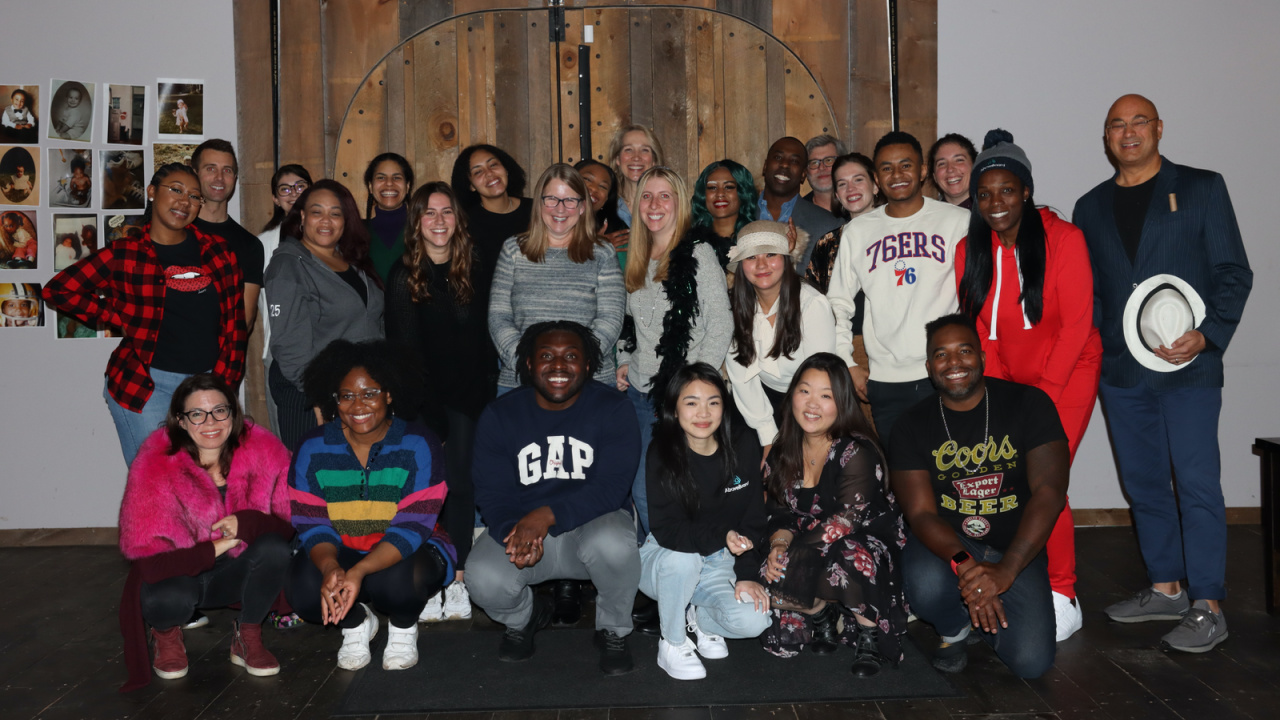 The AboveBoard team — a group of diverse staff smiling for a group photo