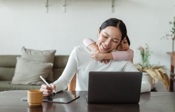 Women working remotely from home with child