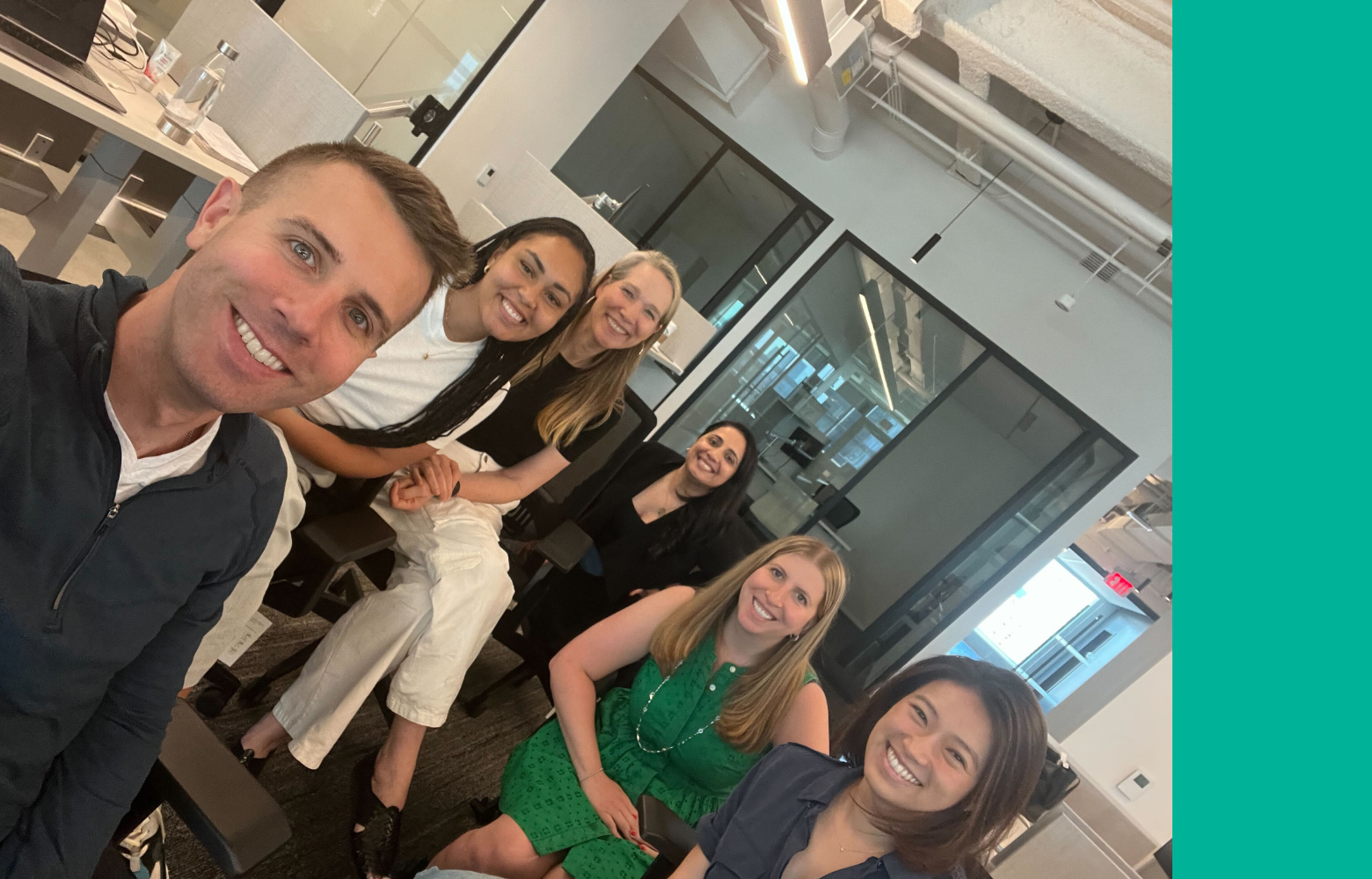 smiling adults sitting in an office